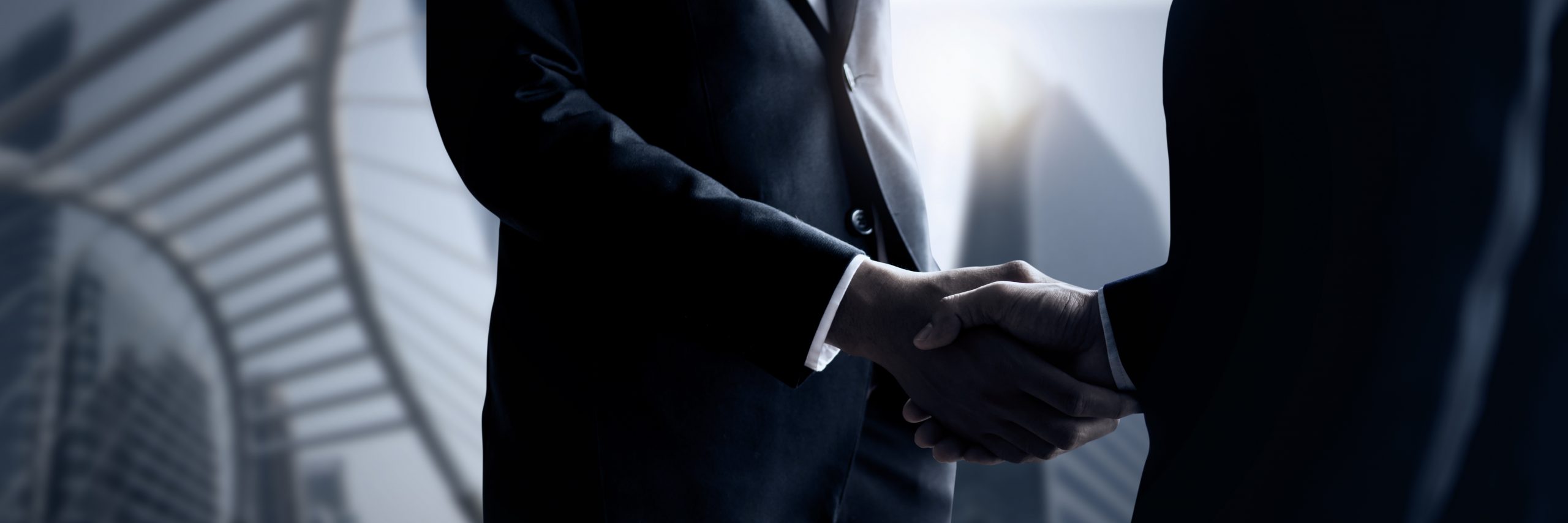 Business people shaking hands, close up hand shake of successful